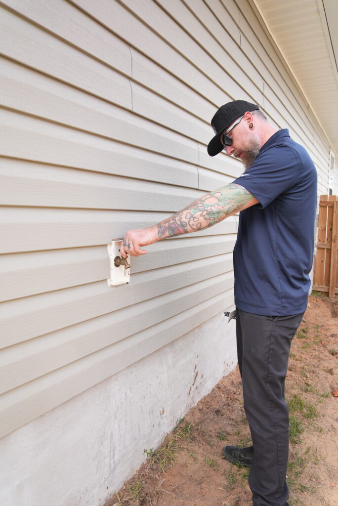 Professional technician performing kitchen inspection on a house.